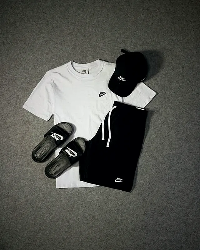 Black and white Nike look with slides and a cap
